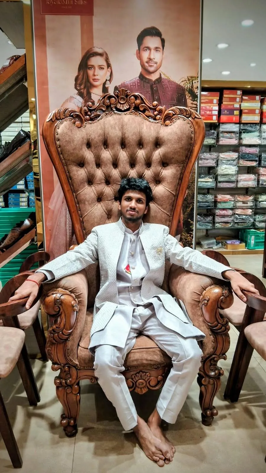 Srujan sitting in an ornate wooden chair